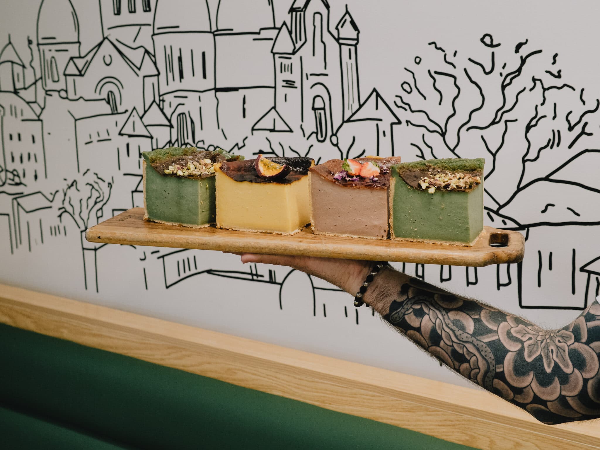 Four assorted cake slices on a board
