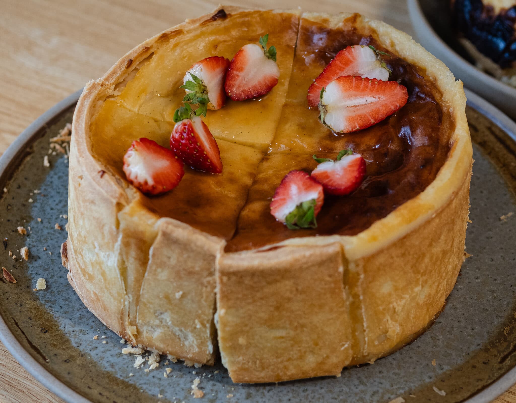 A close-up of a strawberry-topped tart